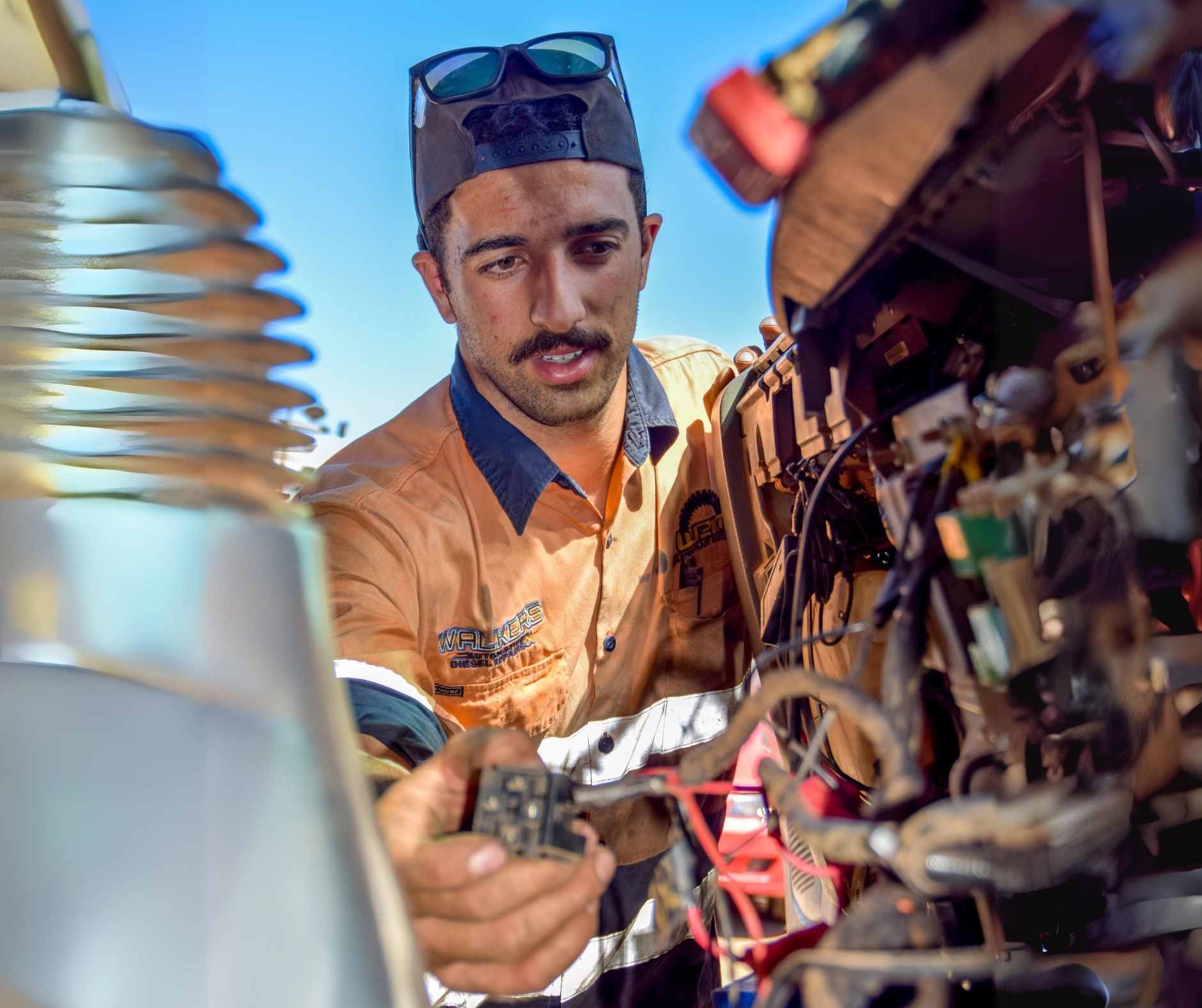 Technician performing auto electrical diagnostics